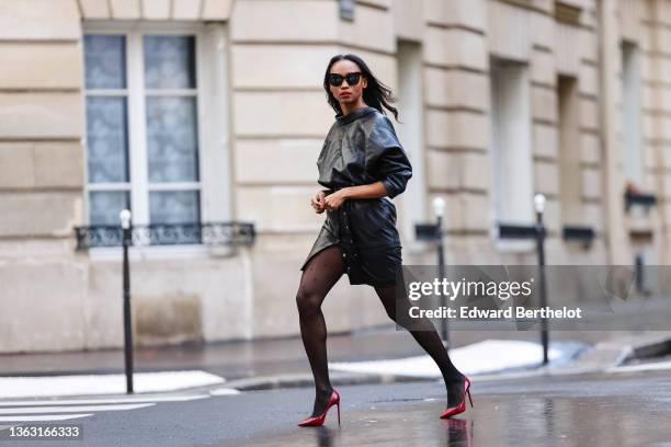 Emilie Joseph @in_fashionwetrust wears sunglasses, an oversized Vintage leather jacket worn as a top, a high waisted lambskin skirt from Iro, ayers...