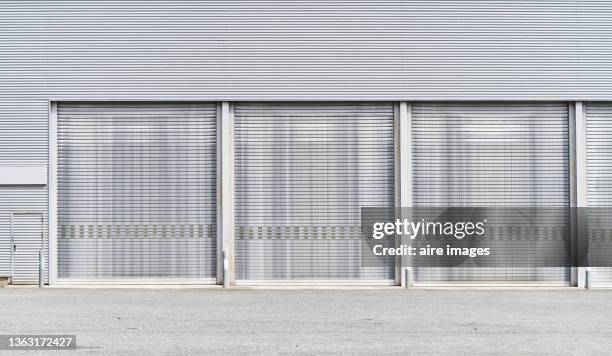 front view of the workshop garage doors. - door canopy stock pictures, royalty-free photos & images