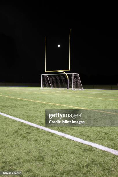 a white ball between the posts on a sports field, scoring - rugby post stock pictures, royalty-free photos & images