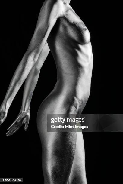 nude caucasian woman with silver body paint standing, side view - female torso stock pictures, royalty-free photos & images