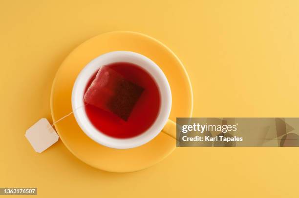 yellow tea cup on a yellow background - tea cup photos et images de collection
