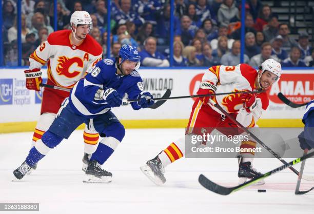 Nikita Kucherov of the Tampa Bay Lightning gets the stick up on Johnny Gaudreau of the Calgary Flames during the second period at the Amalie Arena on...