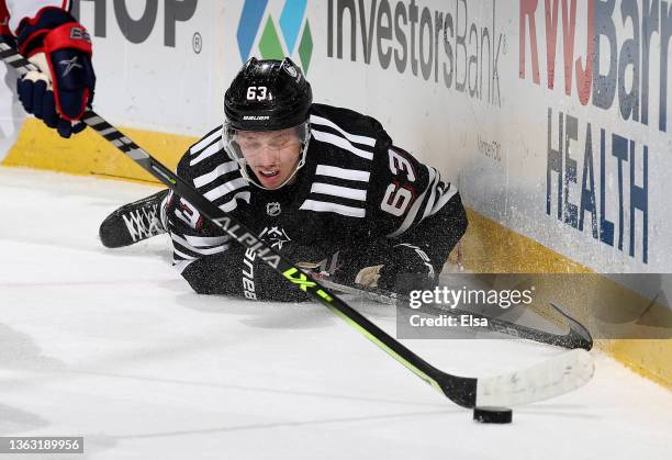 Jesper Bratt of the New Jersey Devils falls as he loses control of the puck during the second period against the Columbus Blue Jackets at Prudential...