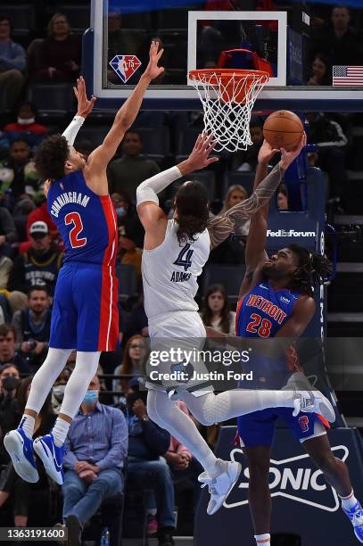 Steven Adams of the Memphis Grizzlies goes to the basket between Cade Cunningham of the Detroit Pistons and Isaiah Stewart of the Detroit Pistons...