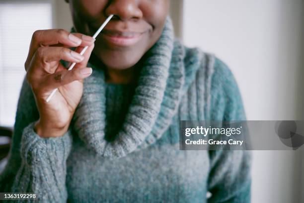 woman takes at-home covid test - cotton bud hand colour stock pictures, royalty-free photos & images