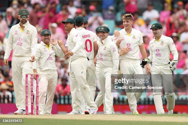 Australian players congratulate Cameron Green of Australia on the wicket of Dawid Malan of England during day three of the Fourth Test Match in the...