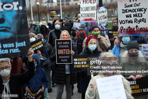 On the one year anniversary of the attack on the US Capitol, Indivisible SF and Indivisible East Bay hold a vigil and march in San Francisco, Calif.,...