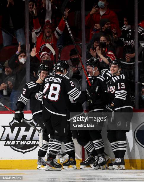 Jesper Bratt of the New Jersey Devils is congratulated by teammates Damon Severson,Jack Hughes,Nathan Bastian and Nico Hischier after Bratt scored...