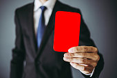 Businessman holding a red card