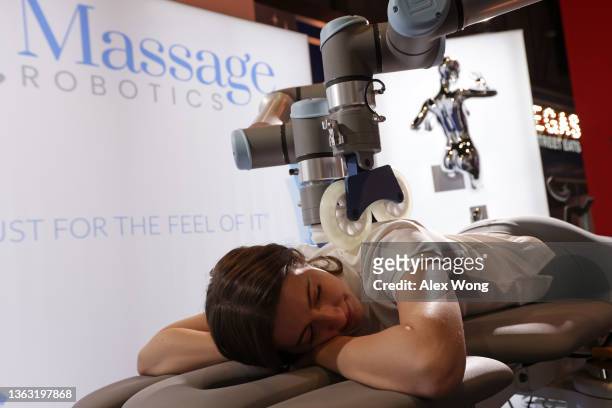 Product Manager Kriston MacKin demonstrates a massage robot at the Massage Robotics booth at CES 2022 at the Las Vegas Convention Center on January...