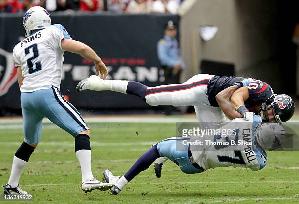 January 01: Special teams player Bryan Braman of the Houston Texans wrestle special teams player Tommie Campbell of the Tennessee Titans on a kick...