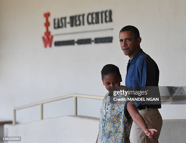 President Barack Obama walks with his daughter Sasha after a visit to the East-West Center at the University of Hawaii January 1, 2012 in Honolulu....