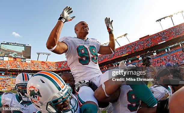 Jason Taylor of the Miami Dolphins is carried off the field after his final game against the New York Jets at Sun Life Stadium on January 1, 2012 in...