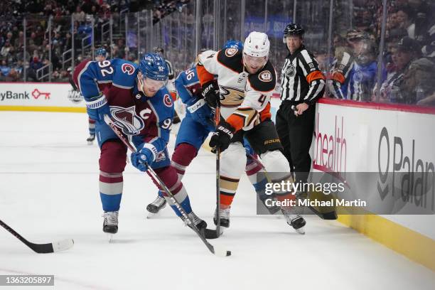 Gabriel Landeskog of the Colorado Avalanche skates against Cam Fowler of the Anaheim Ducks at Ball Arena on January 02, 2022 in Denver, Colorado. The...