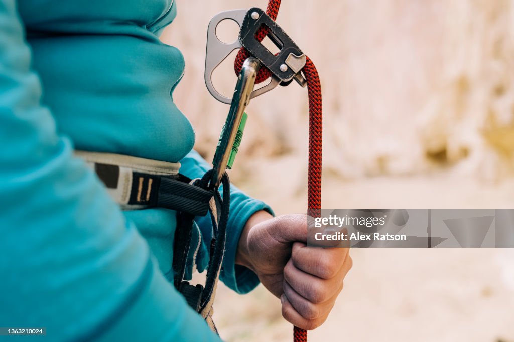 Close up of a rock climbers hands on a climbing rope while belaying