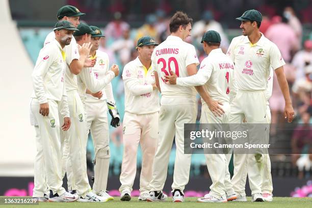 Pat Cummins of Australia celebrates the wicket of Jos Buttler of England during day three of the Fourth Test Match in the Ashes series between...