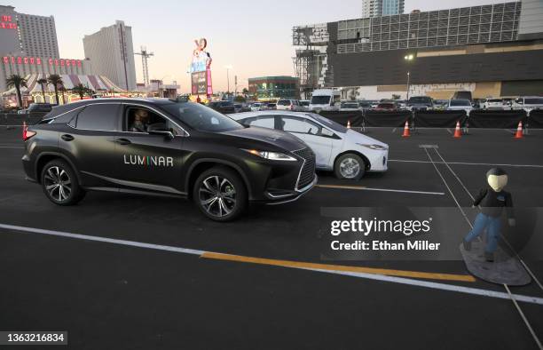 Lexus with Luminar's lidar technology automatically breaks to avoid colliding with a crash test dummy as part of a safety demonstration at CES 2022...