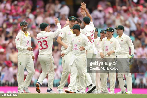 Australian players celebrate the wicket of Jos Buttler of England during day three of the Fourth Test Match in the Ashes series between Australia and...