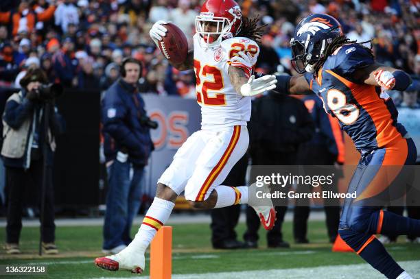 Dexter McCluster of the Kansas City Chiefs runs in for a touchdown against Quinton Carter of the Denver Broncos during the game at Sports Authority...