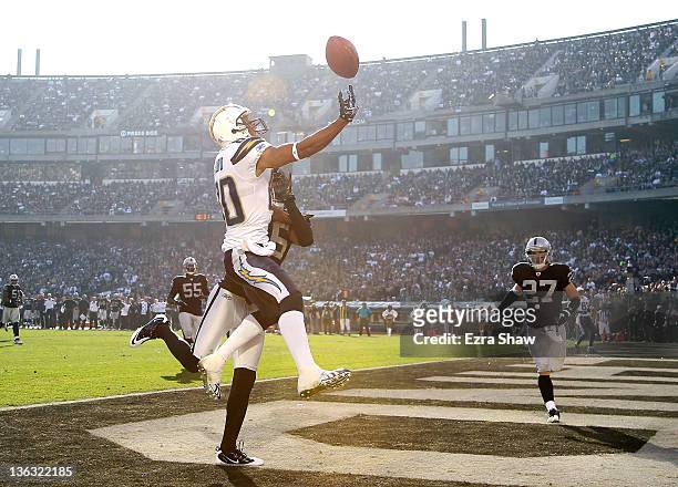 Malcom Floyd of the San Diego Chargers jumps up for a pass in the endzone at O.co Coliseum on January 1, 2012 in Oakland, California. Stanford Routt...