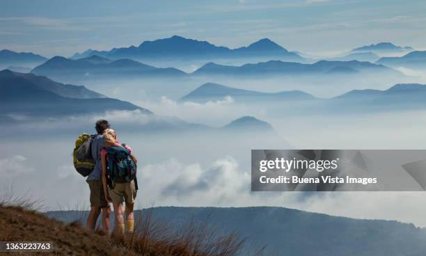 couple watching morning fog among mountains - summit love courage stock pictures, royalty-free photos & images