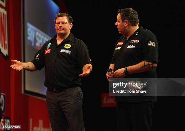 James Wade of England and Adrian Lewis of England complain about the conditions of play during the World Darts Championships Semi Final Match at...