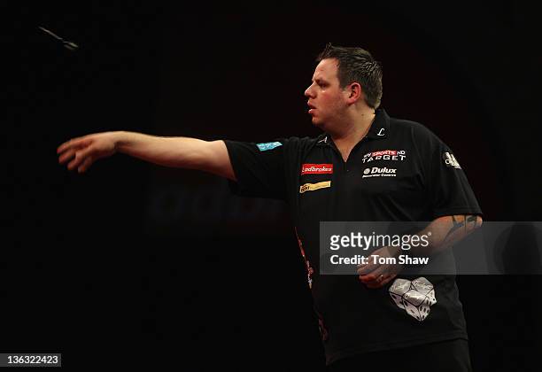 Adrian Lewis of England in action in his match against James Wade of England during the World Darts Championships Semi Final Match at Alexandra...