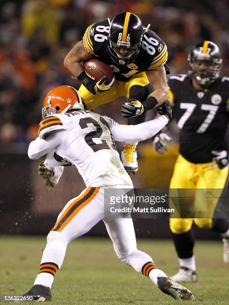 Wide receiver Hines Ward of the Pittsburgh Steelers jumps over defensive back Dimitri Patterson of the Cleveland Browns at Cleveland Browns Stadium...