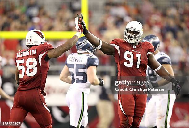 Vonnie Holliday of the Arizona Cardinals high-fives Daryl Washington after a defensive stop against the Seattle Seahawks during the NFL game at the...