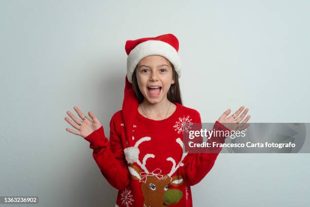 smiling girl in santa hat - christmas jumper stock pictures, royalty-free photos & images