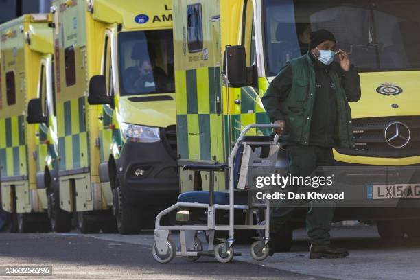 Member of NHS walks with a trolly at the Royal London Hospital on January 07, 2022 in London, England. By the New Year, nearly one in 10 NHS staff...