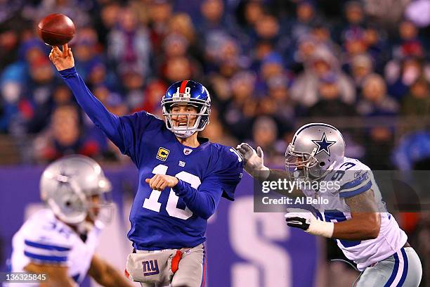 Eli Manning of the New York Giants looks to pass Anthony Spencer of the Dallas Cowboys at MetLife Stadium on January 1, 2012 in East Rutherford, New...