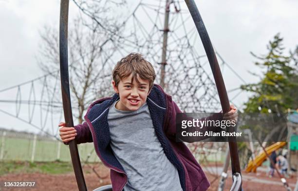 boy (8-9 years old) playing in outdoor park - 8 9 years stock-fotos und bilder