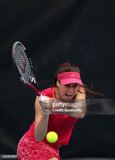 Sorana Cirstea of Romania plays a shot in her match against Flavia Pennetta of Italy during day one of the 2012 ASB Classic at ASB Tennis Centre on...