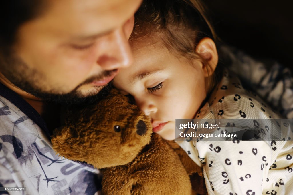 Young father and daughter taking a nap together