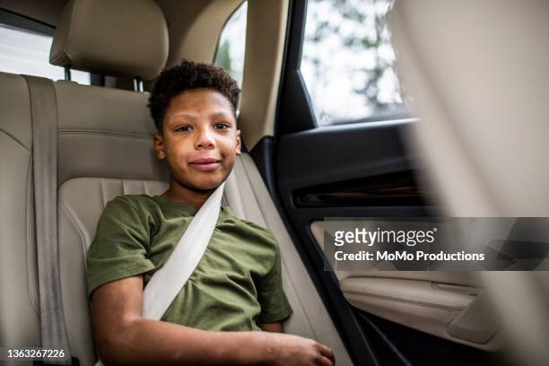portrait of tween boy in the back of car - safe kids day arrivals stock pictures, royalty-free photos & images