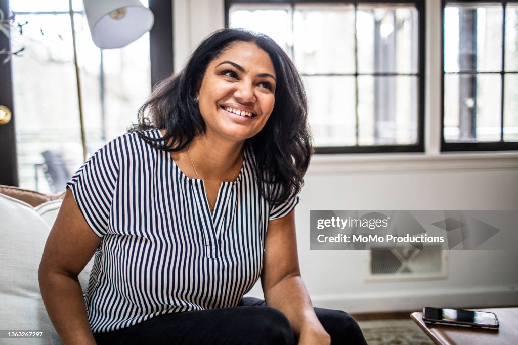 Portrait of mother at home in residential living room