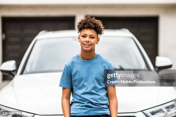 portrait of teenage boy in front of his first car - boy with car stock-fotos und bilder