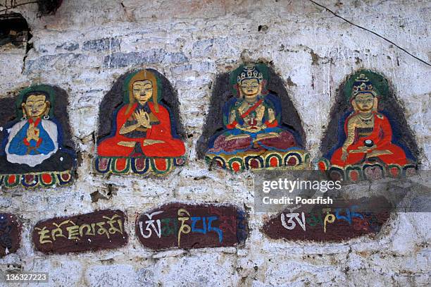 buddhas on wall - buddha painting stock pictures, royalty-free photos & images