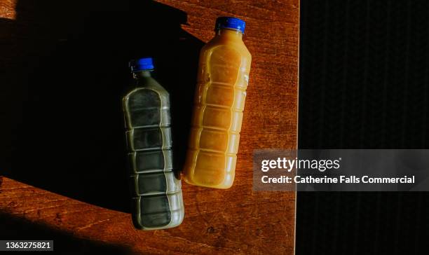top down image of two bottles of fresh juices in different flavours - juice box stock pictures, royalty-free photos & images