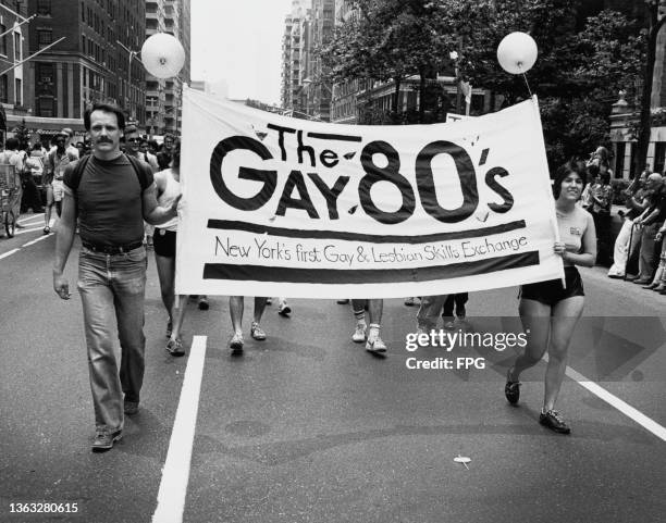 Sign for 'The Gay 80's, New York's first Gay & Lesbian Skills Exchange' during the Gay Pride March in New York City, USA, circa 1985.