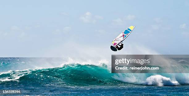 windsurfer flying over wave - windsurf stockfoto's en -beelden