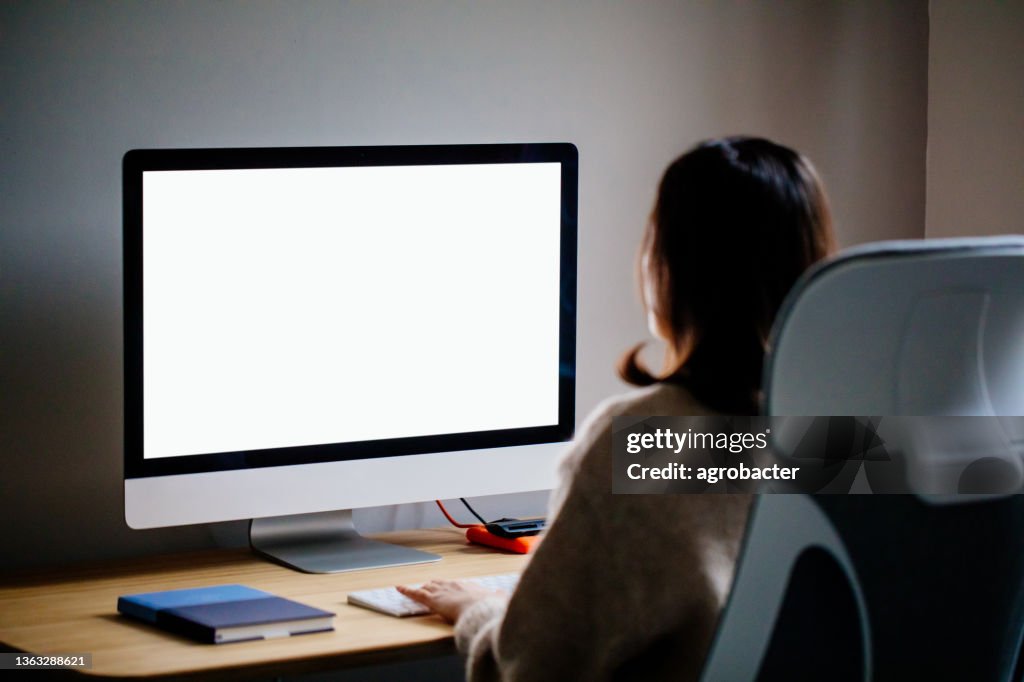 Woman Working At Home With Blank Screen Pc