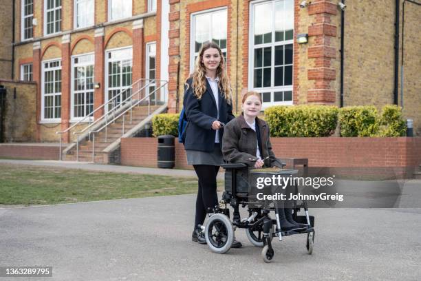 campus portrait of secondary schoolgirls on the way to class - british culture walking stock pictures, royalty-free photos & images