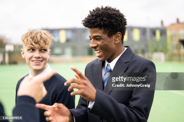 candid outdoor portrait of playful schoolboys on campus - schoolboy stock pictures, royalty-free photos & images