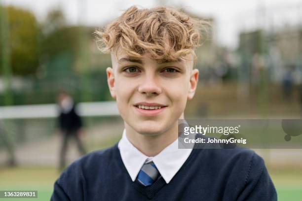 head and shoulder portrait of teenage schoolboy in uniform - boy curly blonde stock pictures, royalty-free photos & images