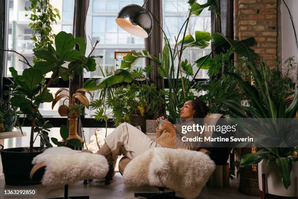 small group of women interact in boho co-working space - chicago lifestyle stock pictures, royalty-free photos & images