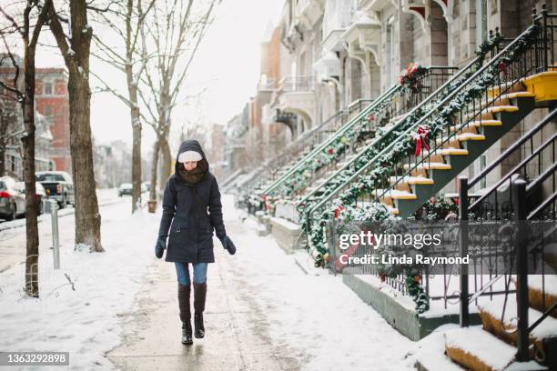 young woman walking in the street of montreal - pedestrian walkway stock pictures, royalty-free photos & images