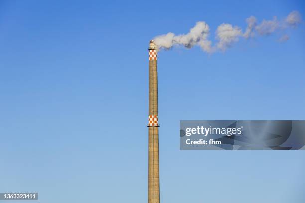 tall chimney with exhaust gases - chimney stock pictures, royalty-free photos & images