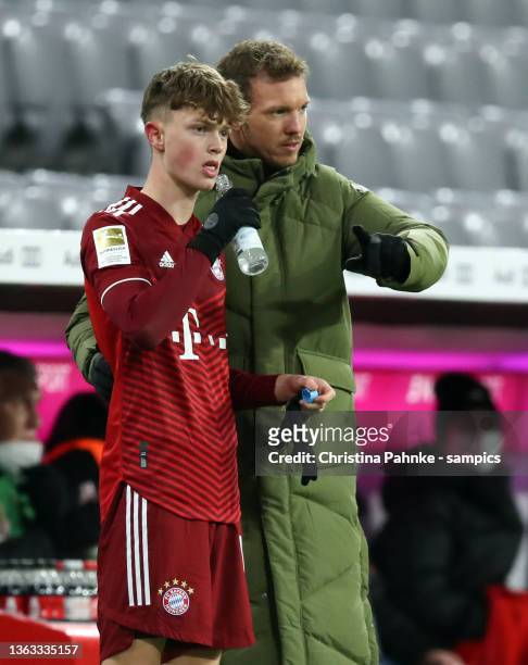 Coach Julian Nagelsmann of Bayern Muenchen with Paul Wanner of FC Bayern Muenchen during the Bundesliga match between FC Bayern München and Borussia...